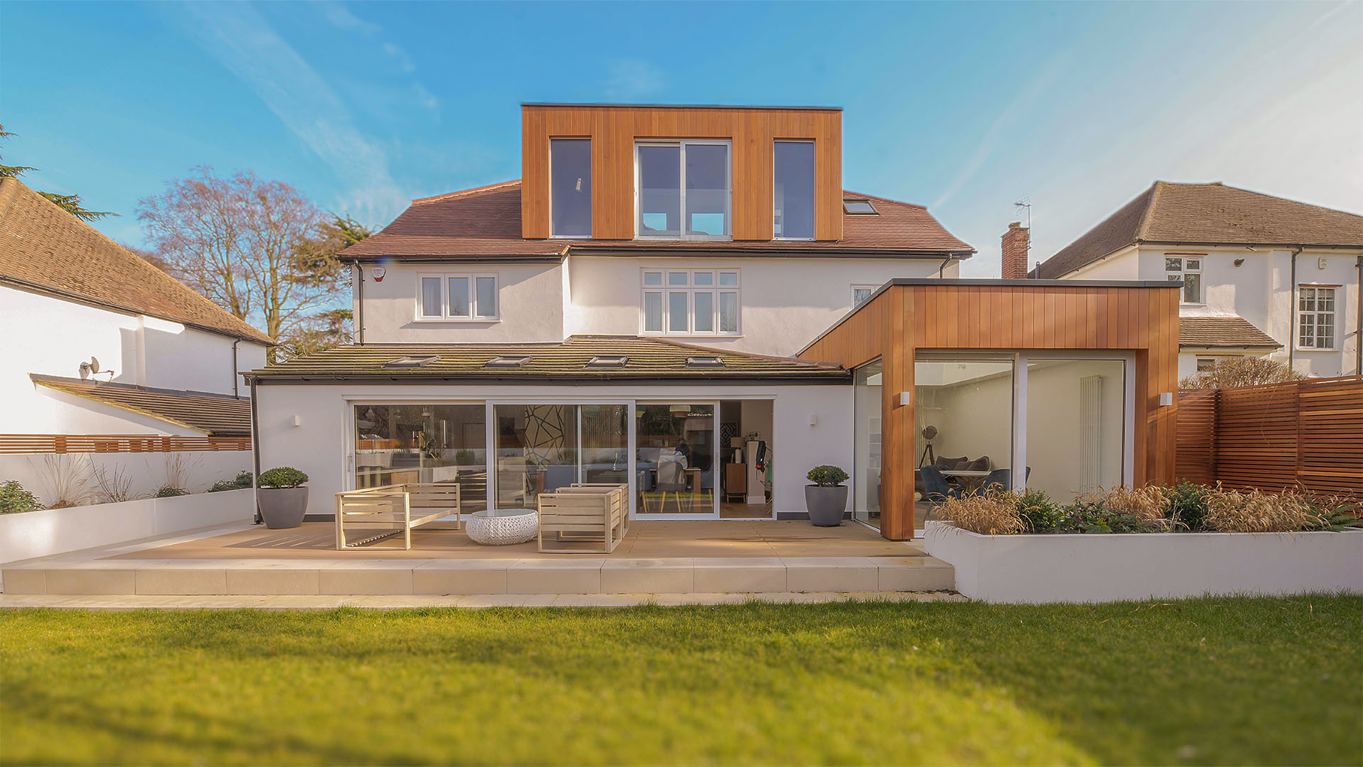 Rear extension with cedar cladding and loft conversion by KJC Architects